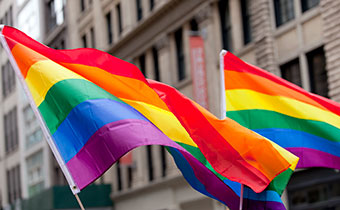 2 rainbow flags waving
