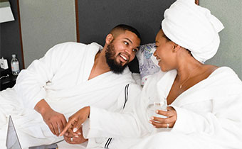 couple in bed with robes on