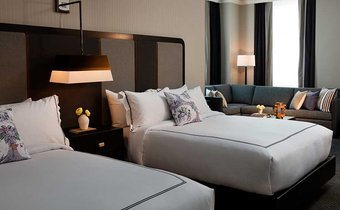 Queen queen suite with living room at Kimpton Cardinal Hotel